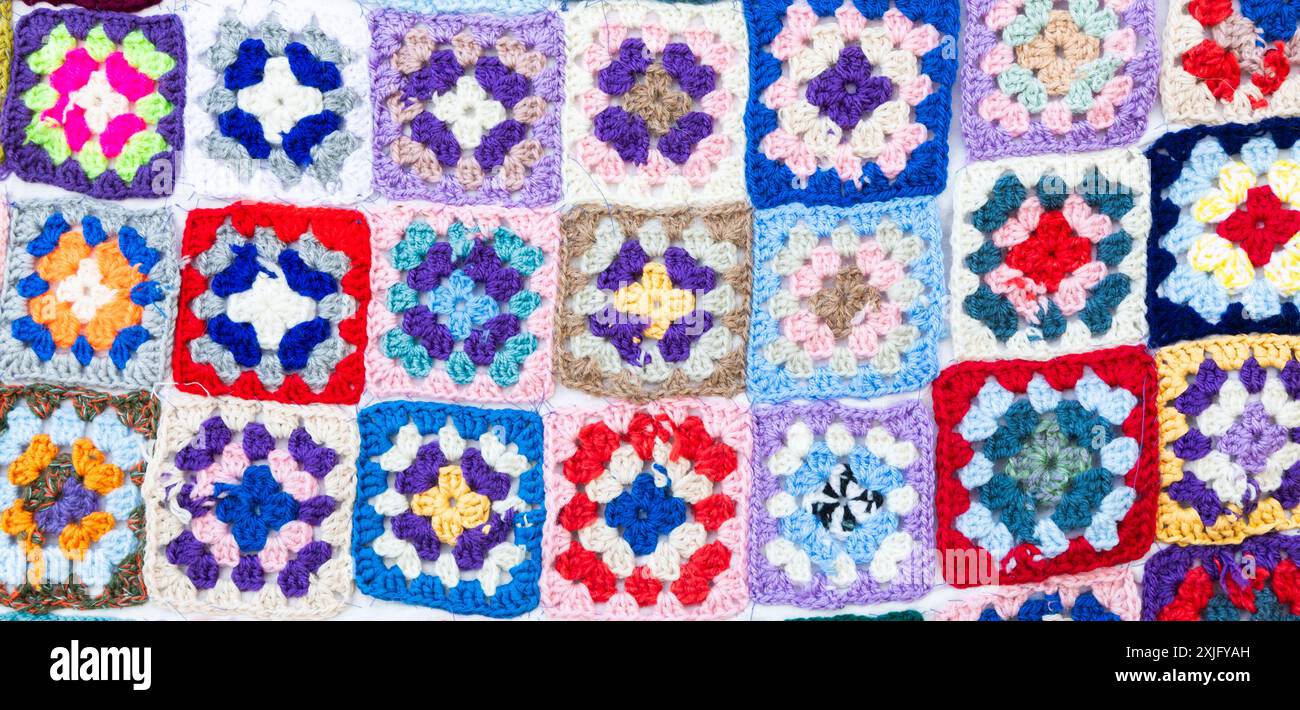 Multi colored blanket in wool, geometric background, retro decorative pattern Stock Photo