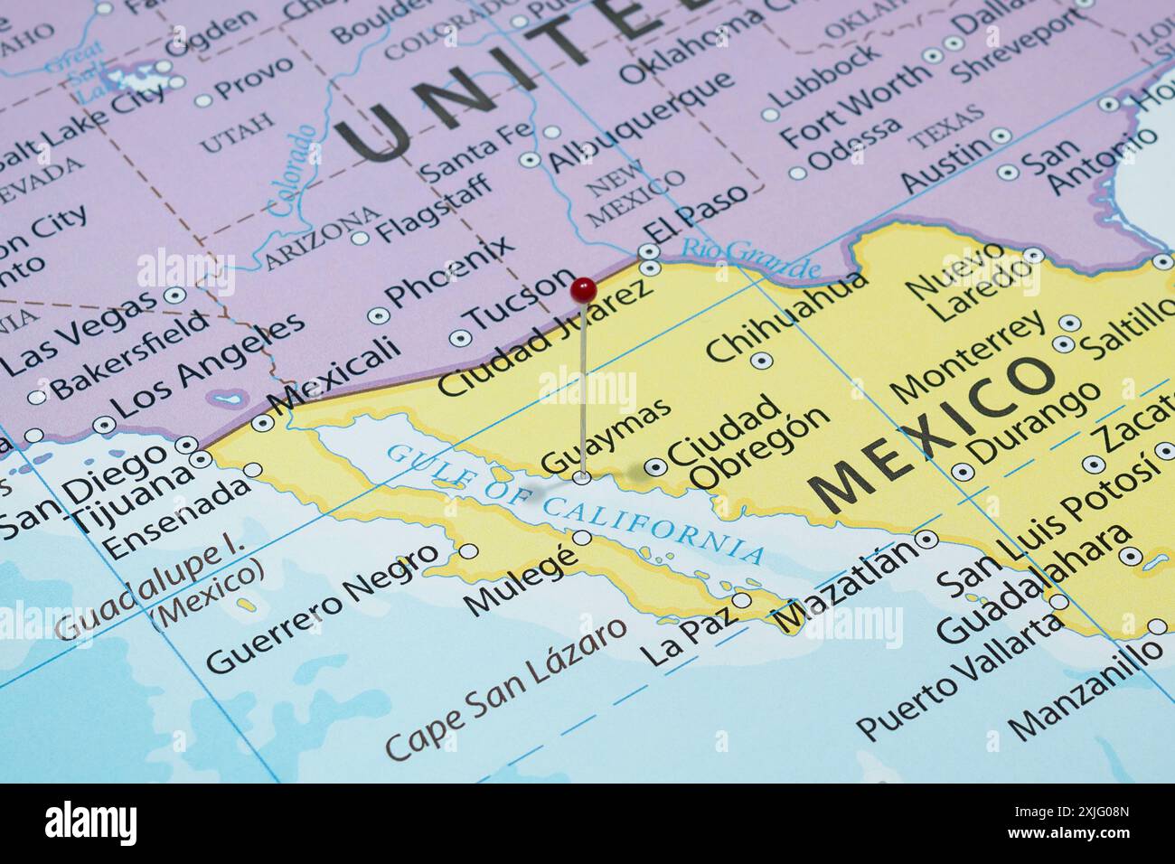 Close up to a Guaymas city with a red pin needle into Mexico country political map Stock Photo
