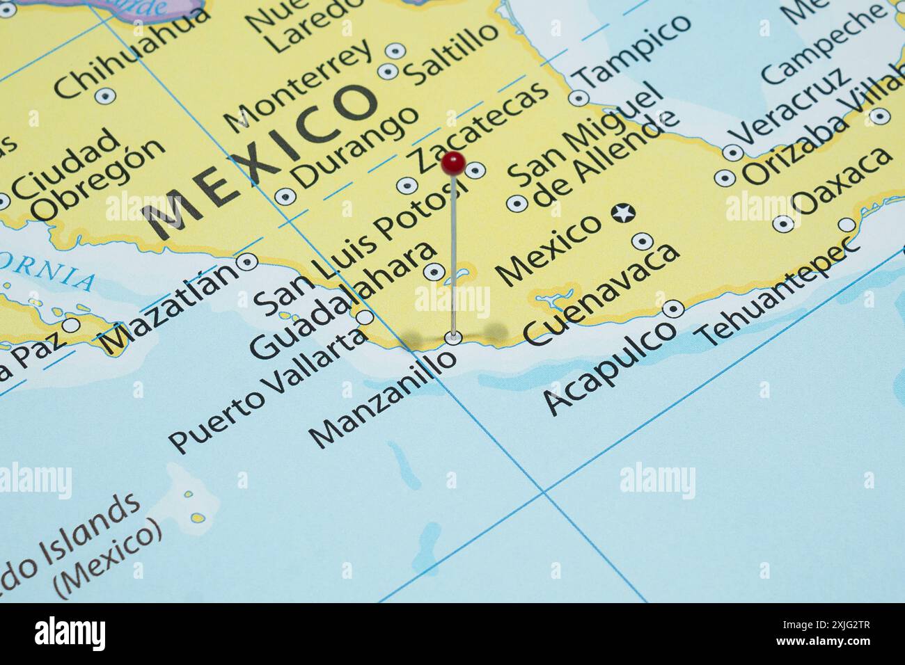 Close up to a Manzanillo city with a red pin needle into Mexico country political map Stock Photo