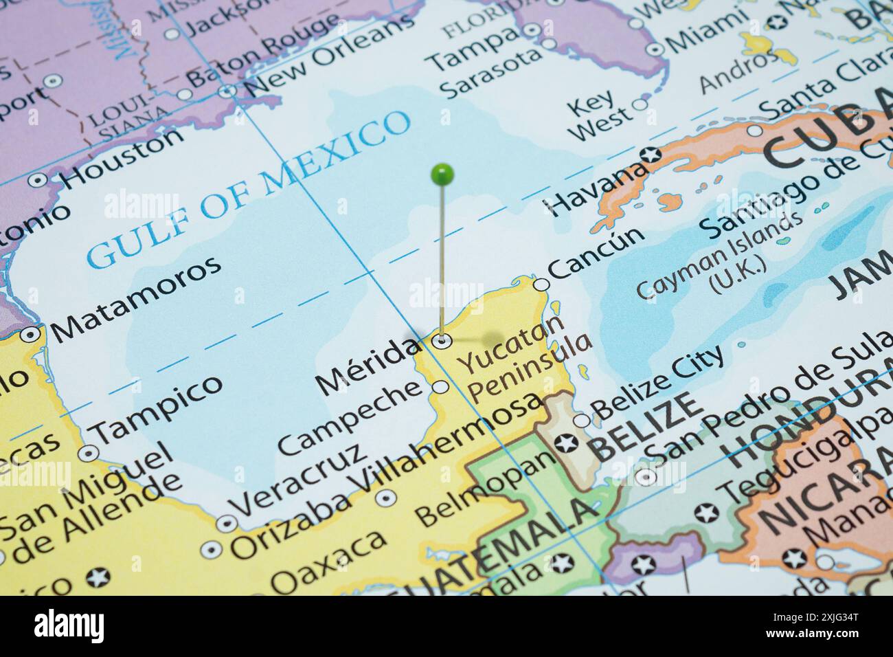 Close up to a Merida city with a green pin needle into Mexico country political map Stock Photo