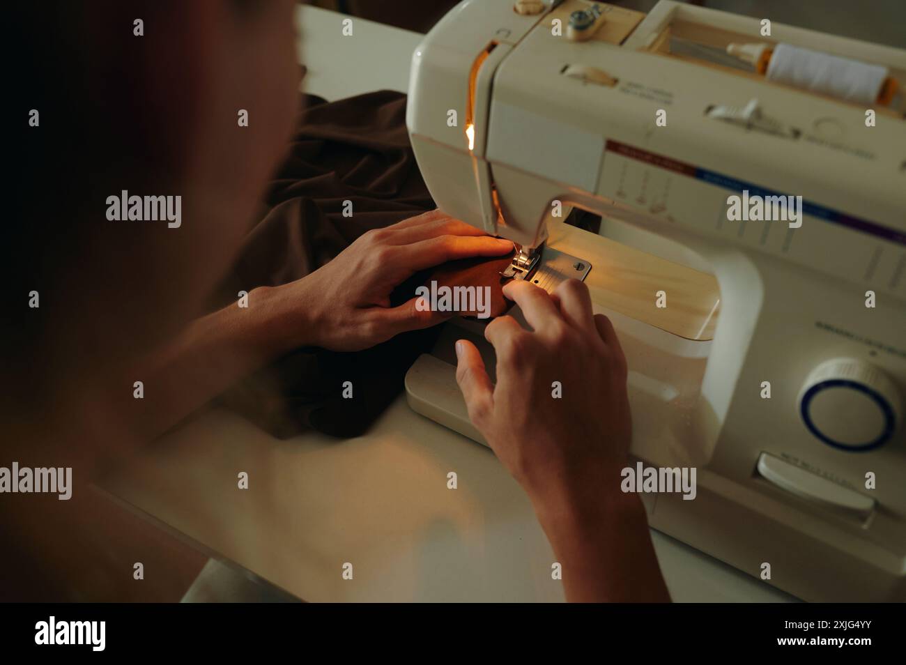 Tailor Using Sewing Machine At His Work Stock Photo