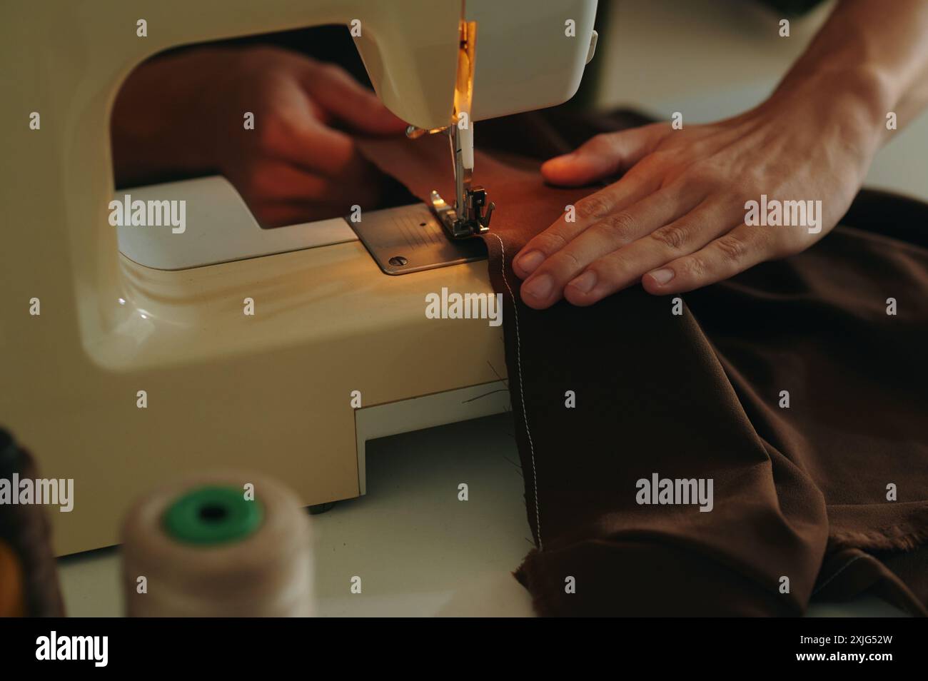 Tailor Using Sewing Machine At Work Stock Photo