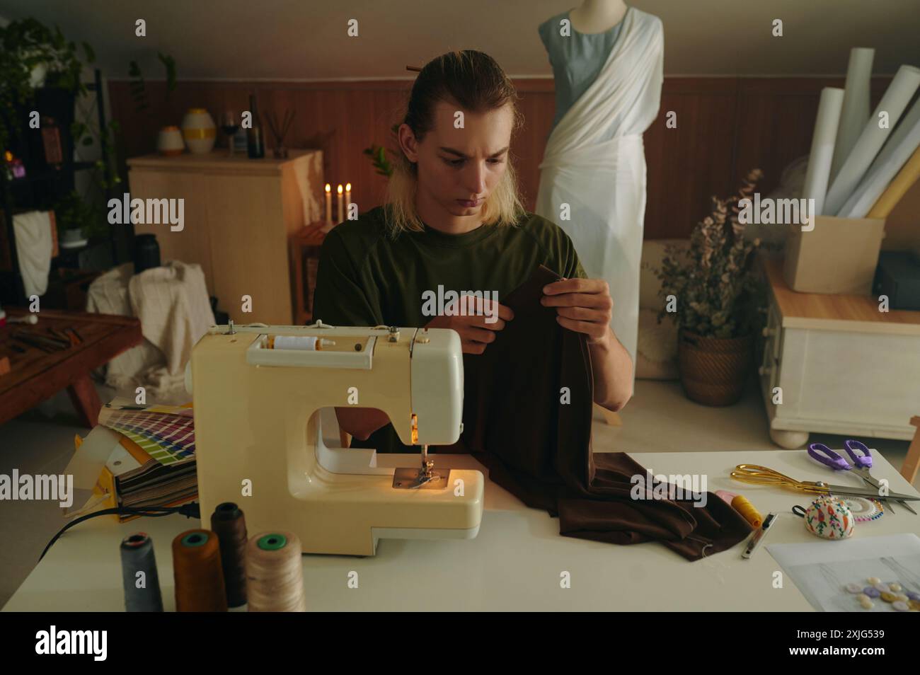 Designer Working With Clothes On Machine Stock Photo