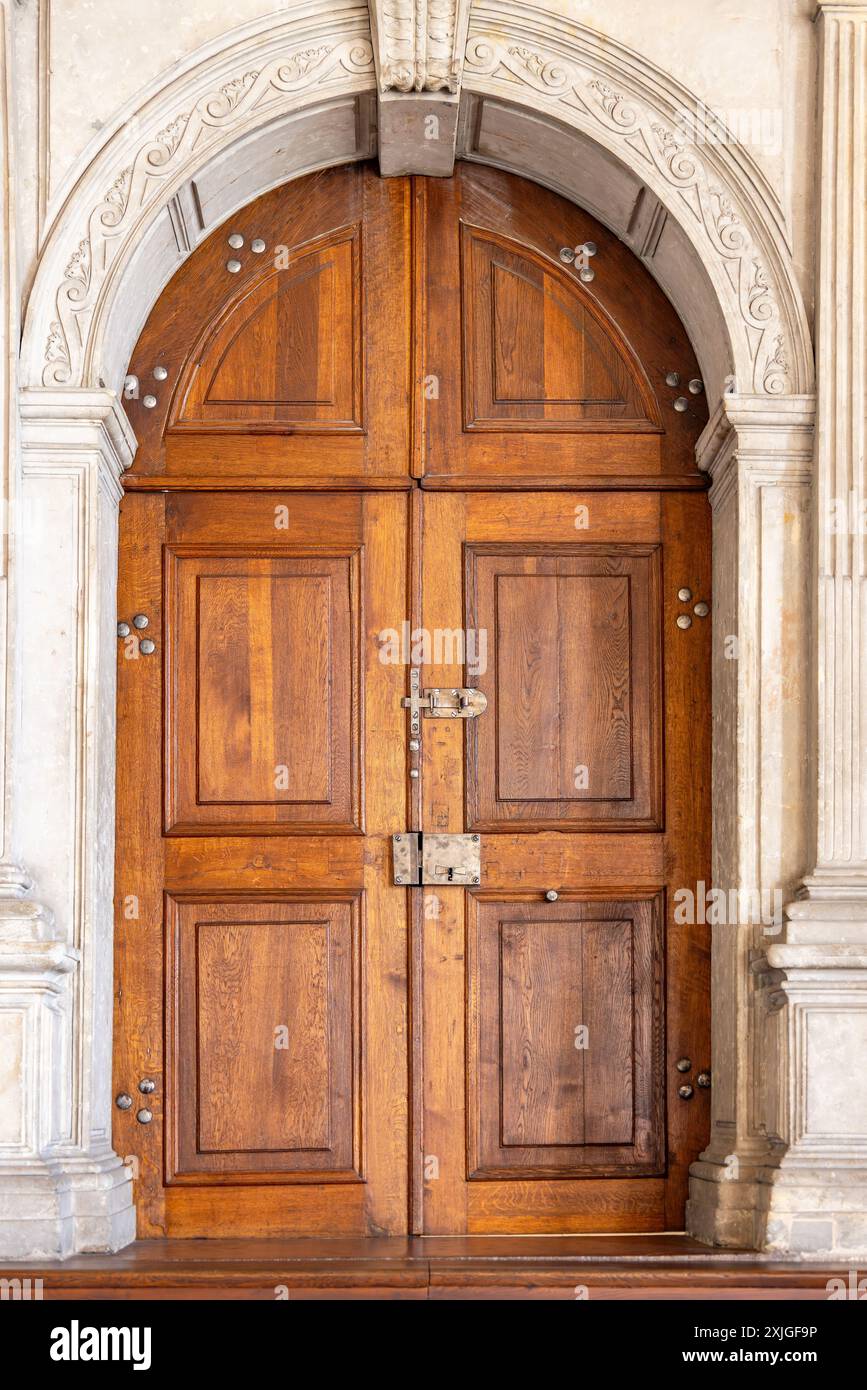 Old wooden door with ornaments in a stone wall, usually used in ...