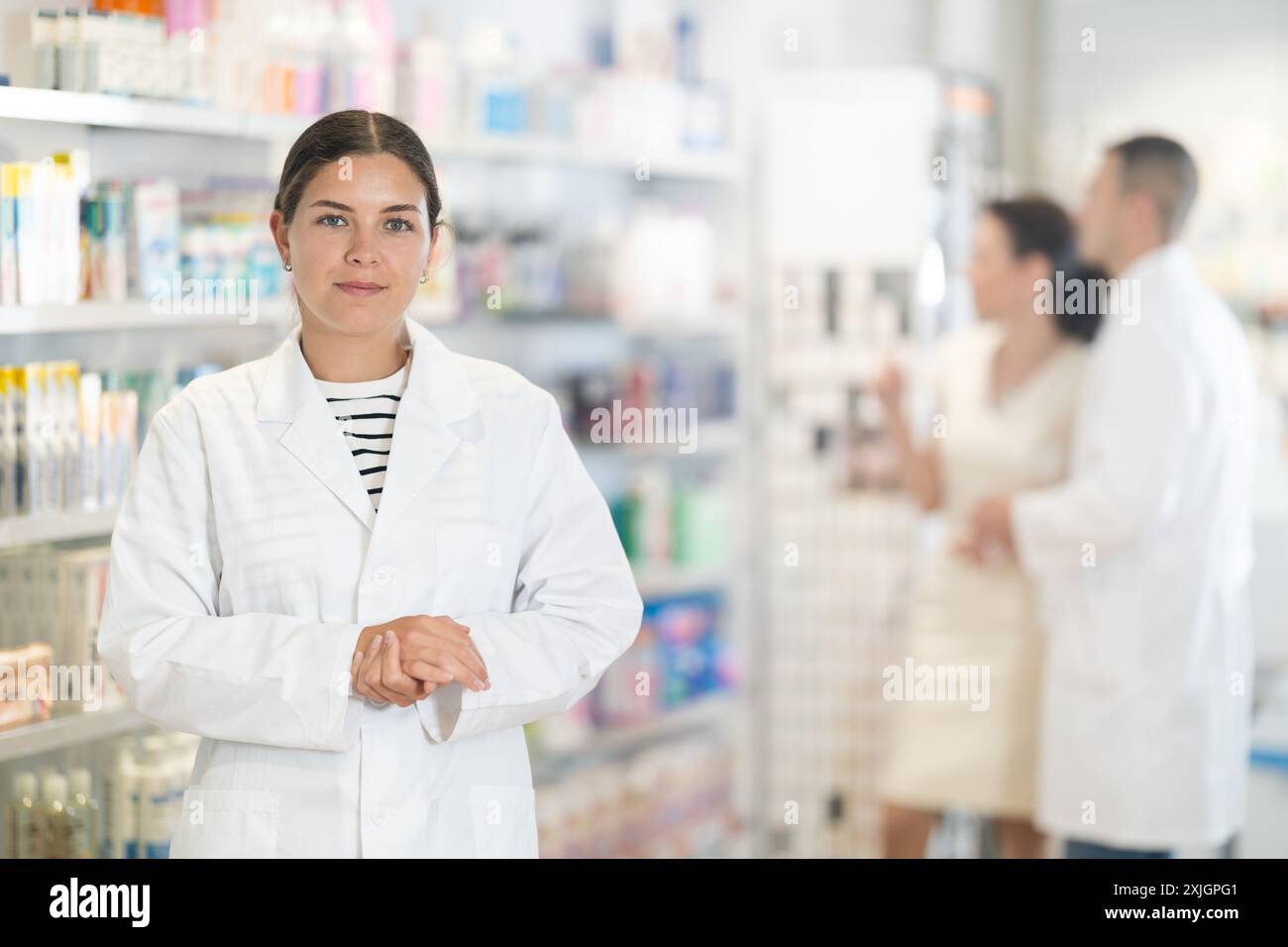 Young female pharmacist posing hi-res stock photography and images - Alamy