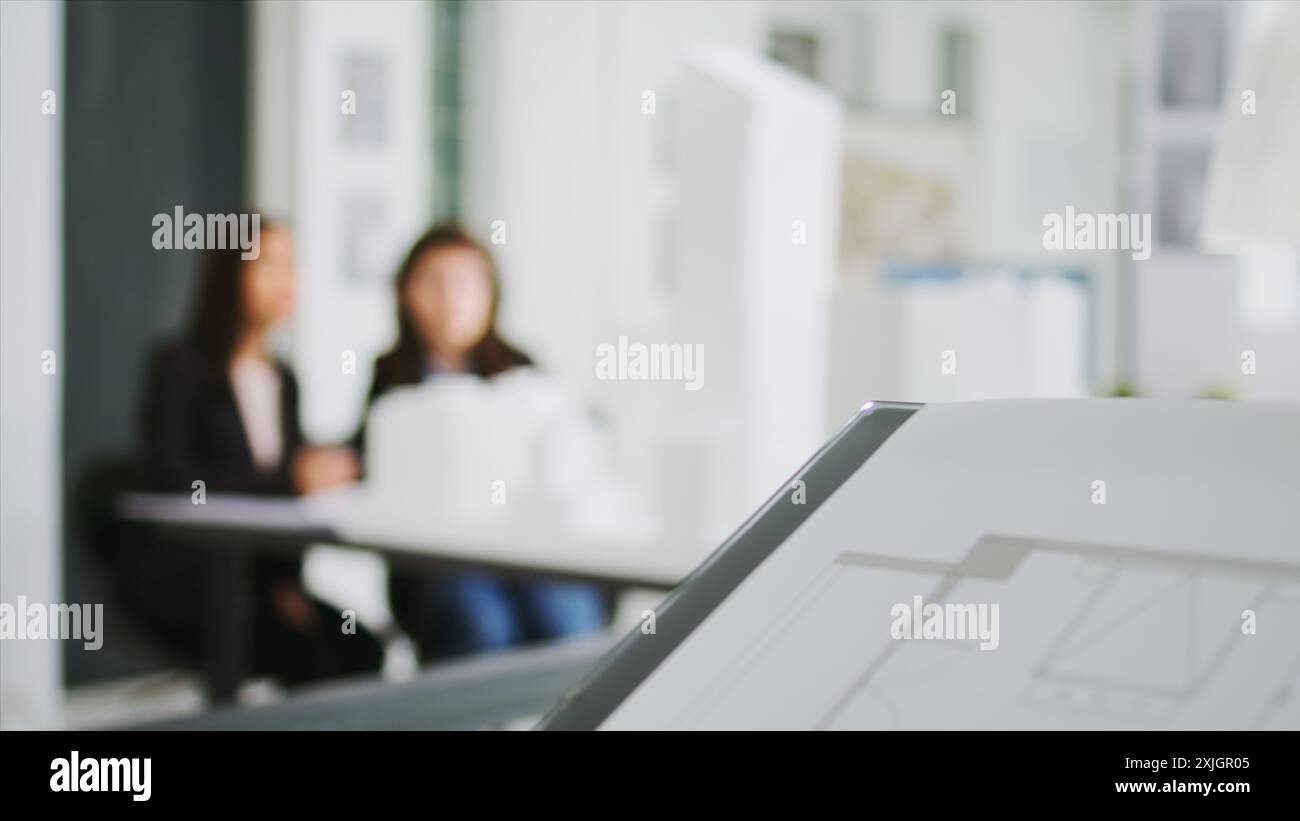 Specialists at creative agency gather data on plans and determine real scale dimensions to guarantee that the building crew gets correct items. Architects researching 3D printed structures. Stock Photo