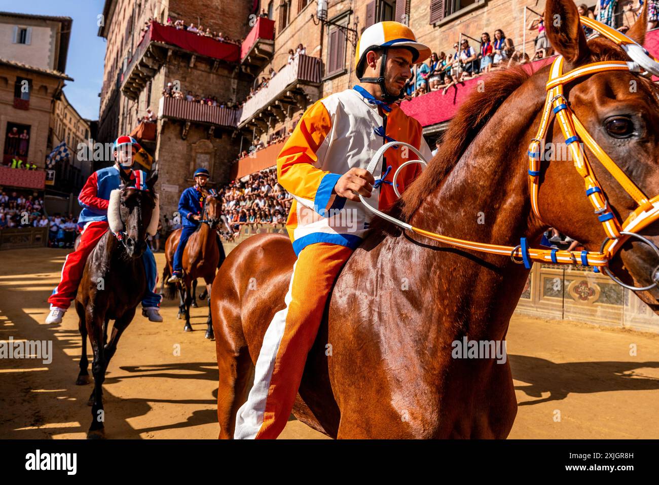 Jockeys Wearing Their Contrada Colours Approach The Start Line For The ...