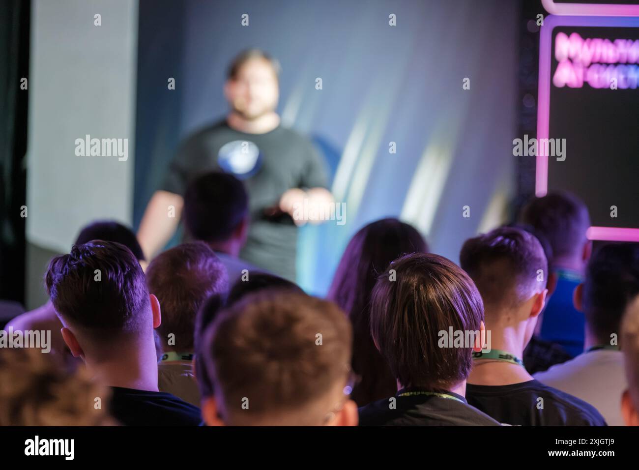 Audience attentively listening to a speaker at a business presentation ...