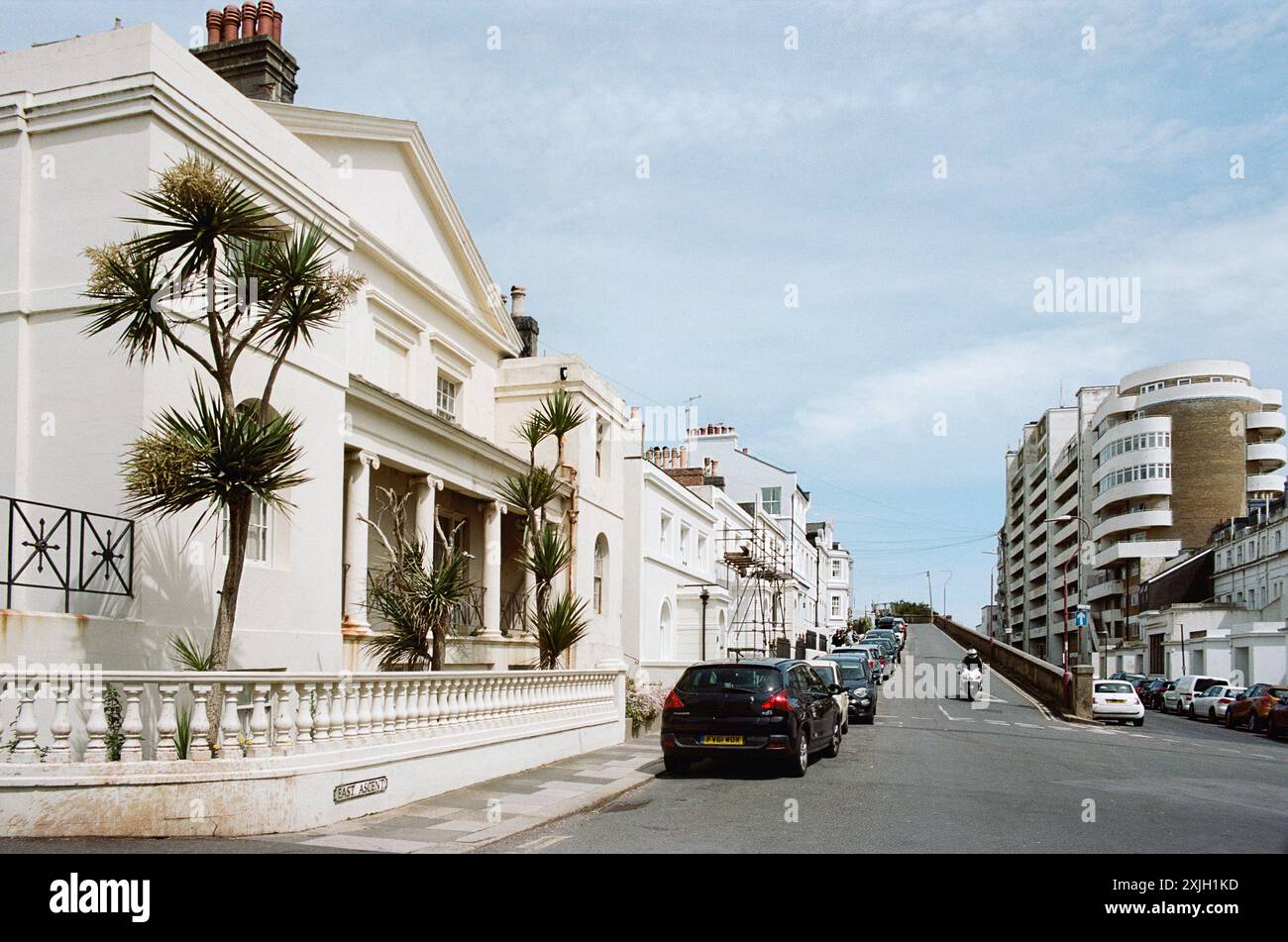 Georgian and Victorian houses along East Ascent, St Leonards-On-Sea, East Sussex, UK, with the 1930's Marine Court building in the background Stock Photo