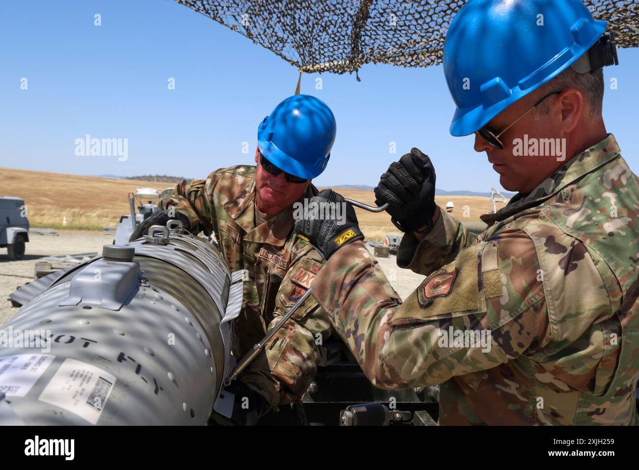 May 21, 2024, Beale Air Force Base, California, USA: U.S. Air Force Lt. Col. Jason Fuhrer, Air Force Life Cycle Management Center Munitions Division materiel leader, and Col. Kenneth Beebe, 51st Maintenance Group commander, tighten tail kit bolts onto the Mark-82 (MK-82) bomb during Exercise Iron Flag, the culmination event of the Air Force Combat Ammunition Course (AFCOMAC) at Beale Air Force Base, California, May 21, 2024. Upwards of 1000 live munitions are assembled by AFCOMAC students during Exercise Iron Flag. (Credit Image: © Frederick BrownU.S. Air Force/ZUMA Press Wire) EDITORIAL USAGE Stock Photo