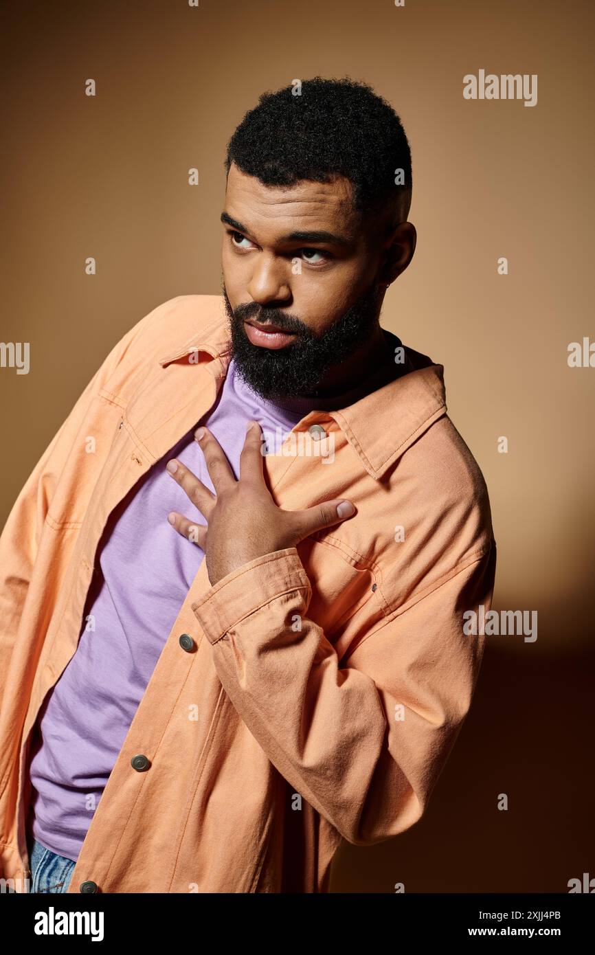 Stylish man with beard in fashionable attire poses confidently. Stock Photo