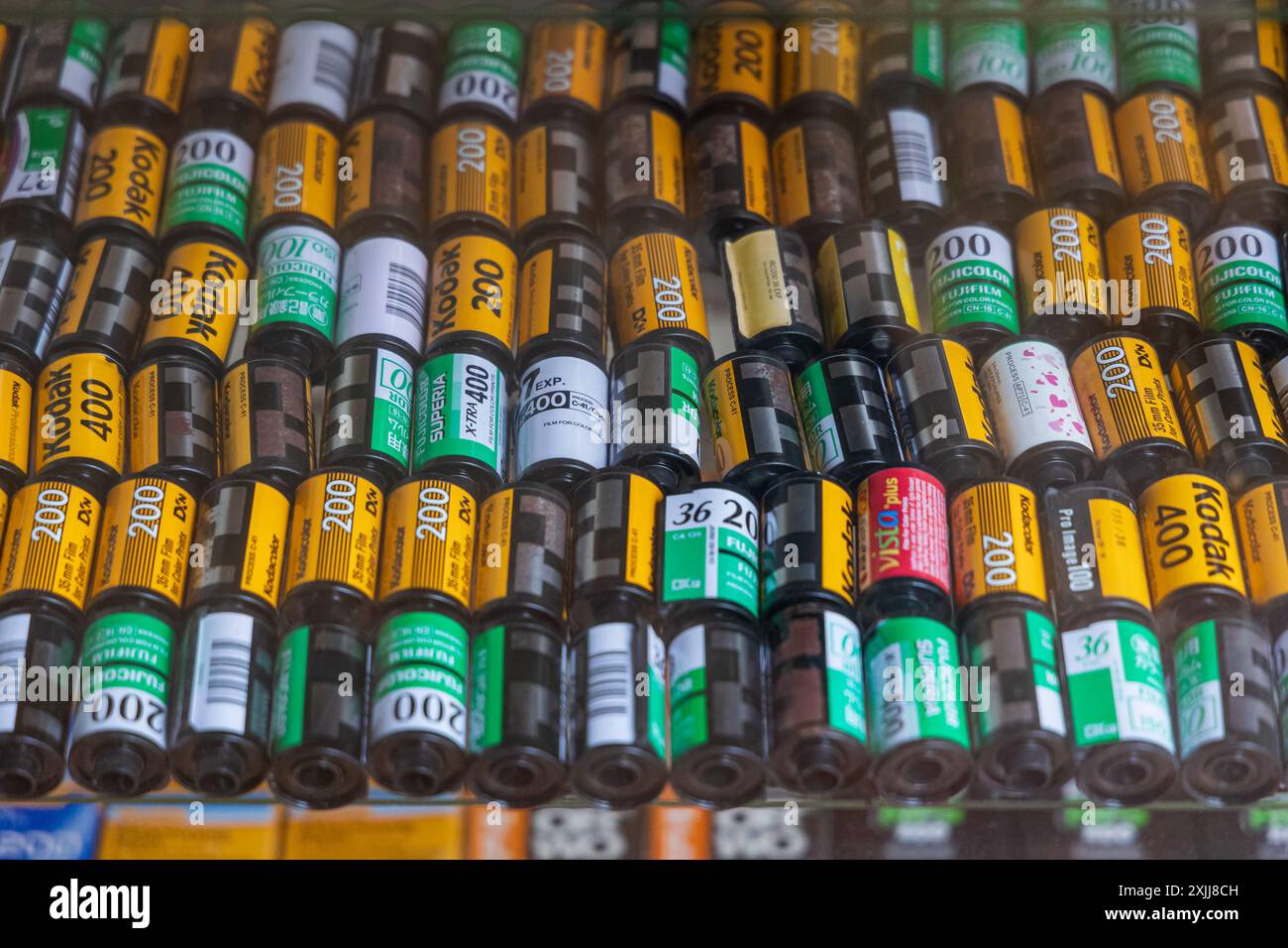 A display of different iso rolls of Kodak and other brands analogue camera film in the showcase inside the shop. Thailand Phuket July 18,2024 Stock Photo