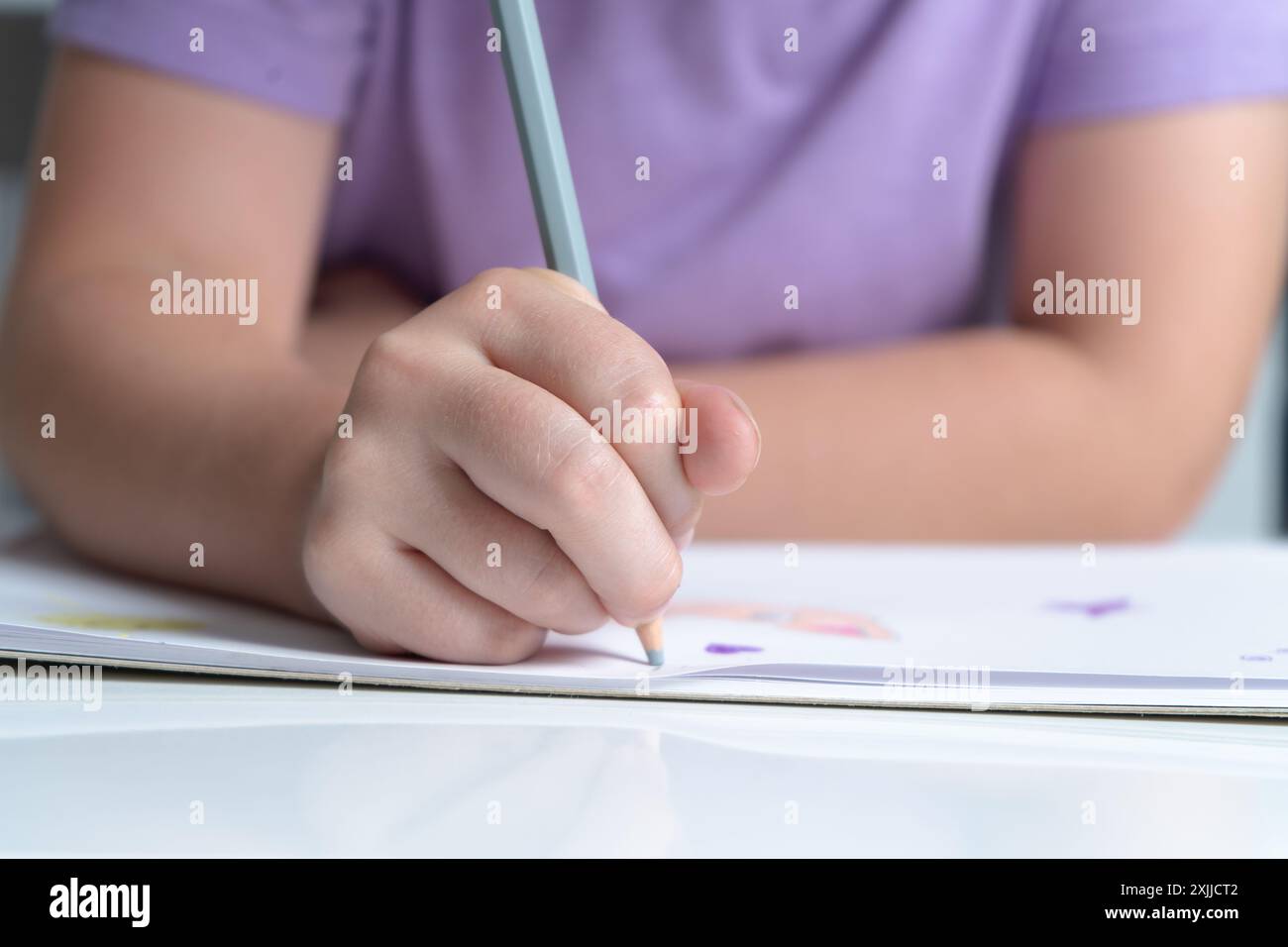 hand holding a colored pencil Stock Photo