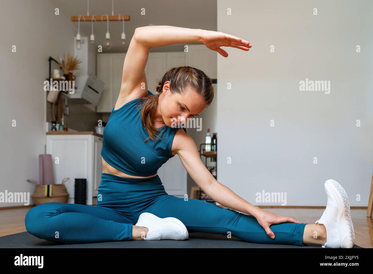 Caucasian woman stretching home hi-res stock photography and images - Alamy