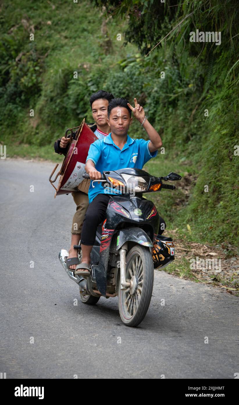 Two men riding on a motorcycle in Lao Cai Province, Northern Vietnam Stock Photo