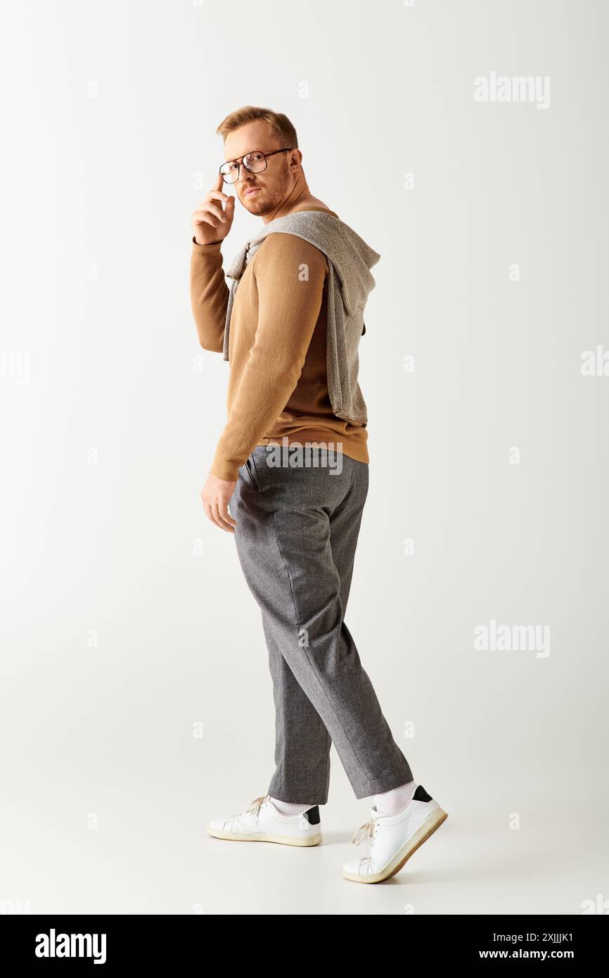 Stylish man walking, white backdrop. Stock Photo