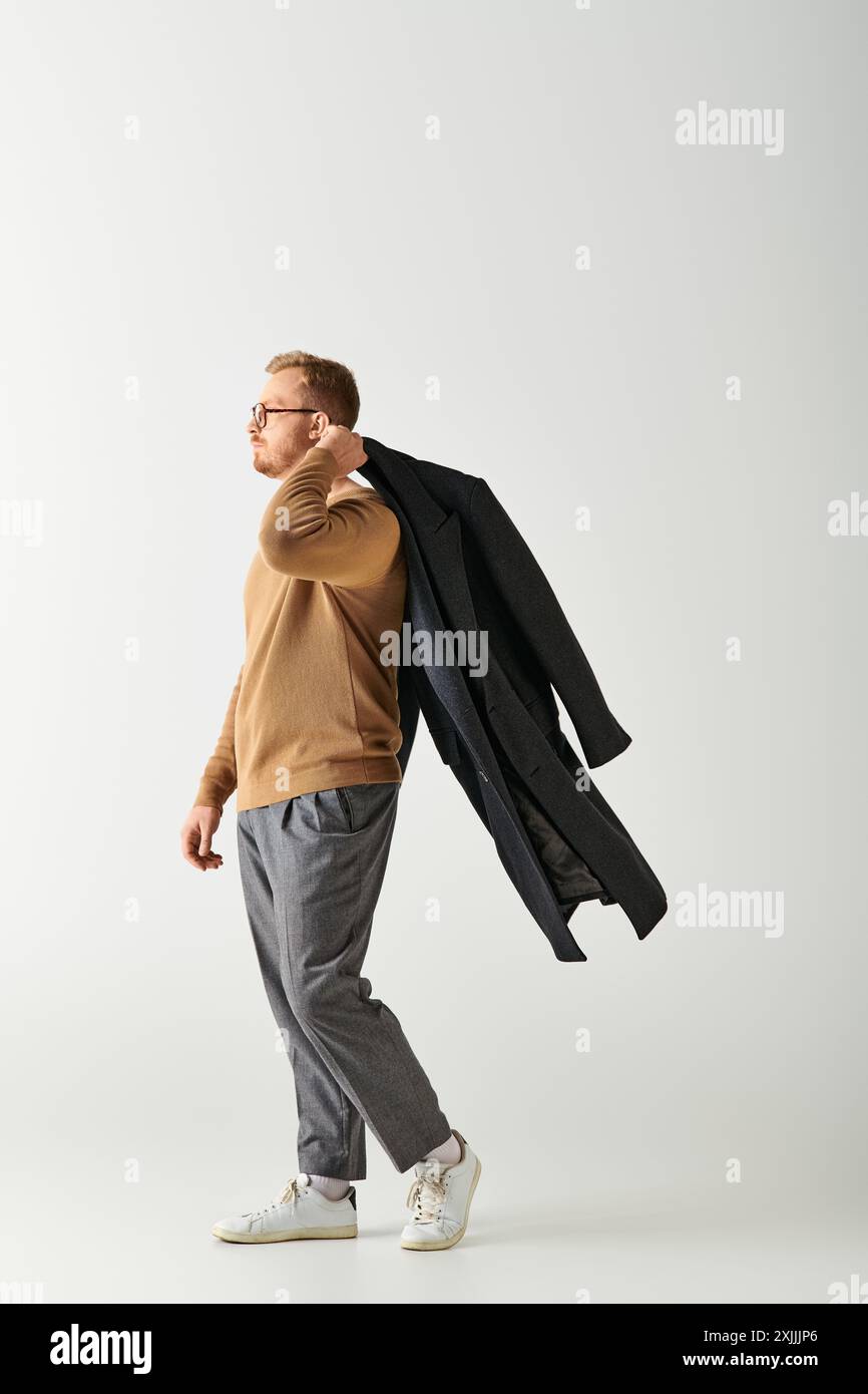 Stylish man walking on white backdrop. Stock Photo