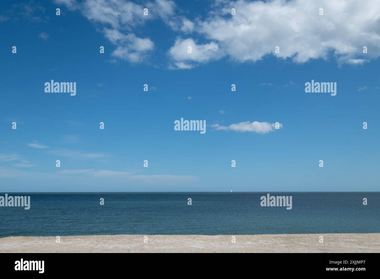 A clear blue sky with a few clouds Stock Photo - Alamy