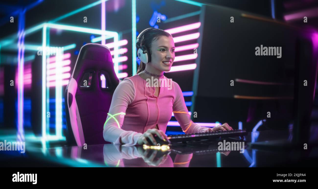 Young Female Gamer Playing Online Video Game on a Computer in a ...