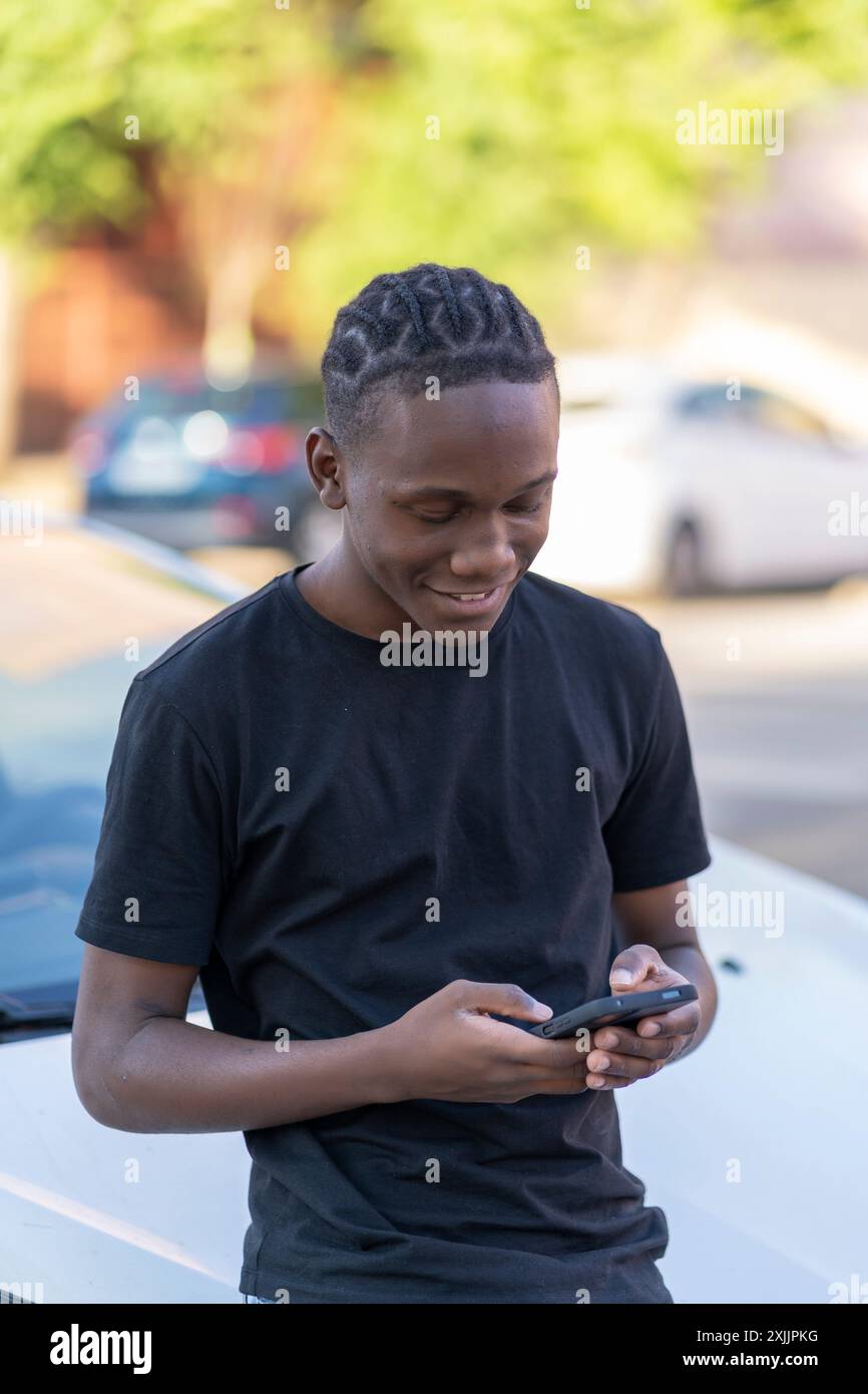young black man using his smartphone Stock Photo