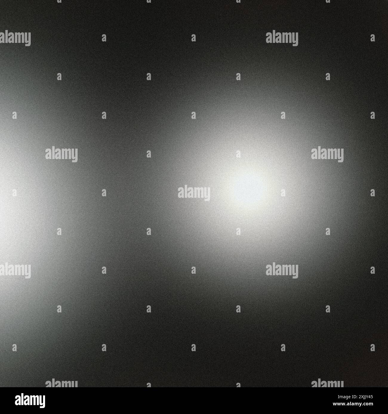 Grainy texture with two light spots creating a gradient on a dark background abstract concept Stock Photo