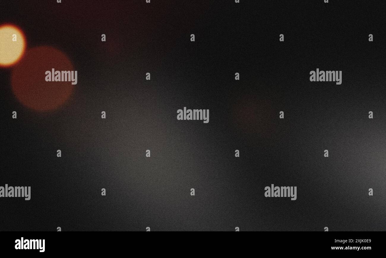 Abstract dark background with blurred lights creating bokeh effect and grainy texture Stock Photo