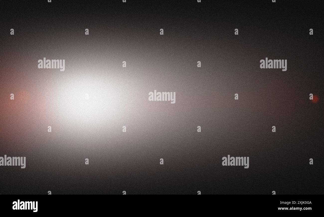 Abstract background featuring a grainy texture with a smooth gradient from white to black Stock Photo