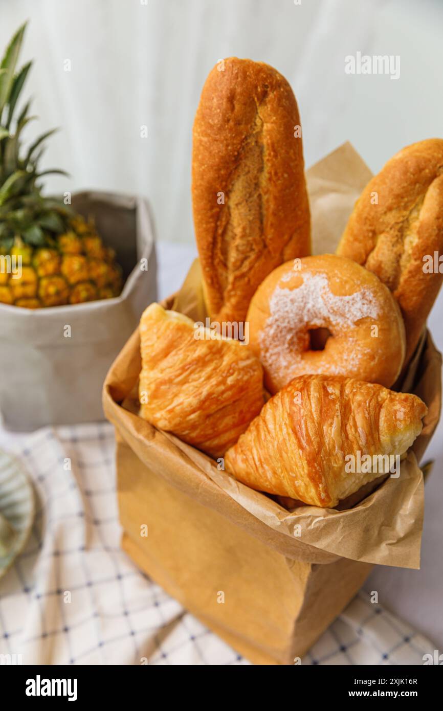 Basket of freshly baked buns on a table in a bakery Stock Photo