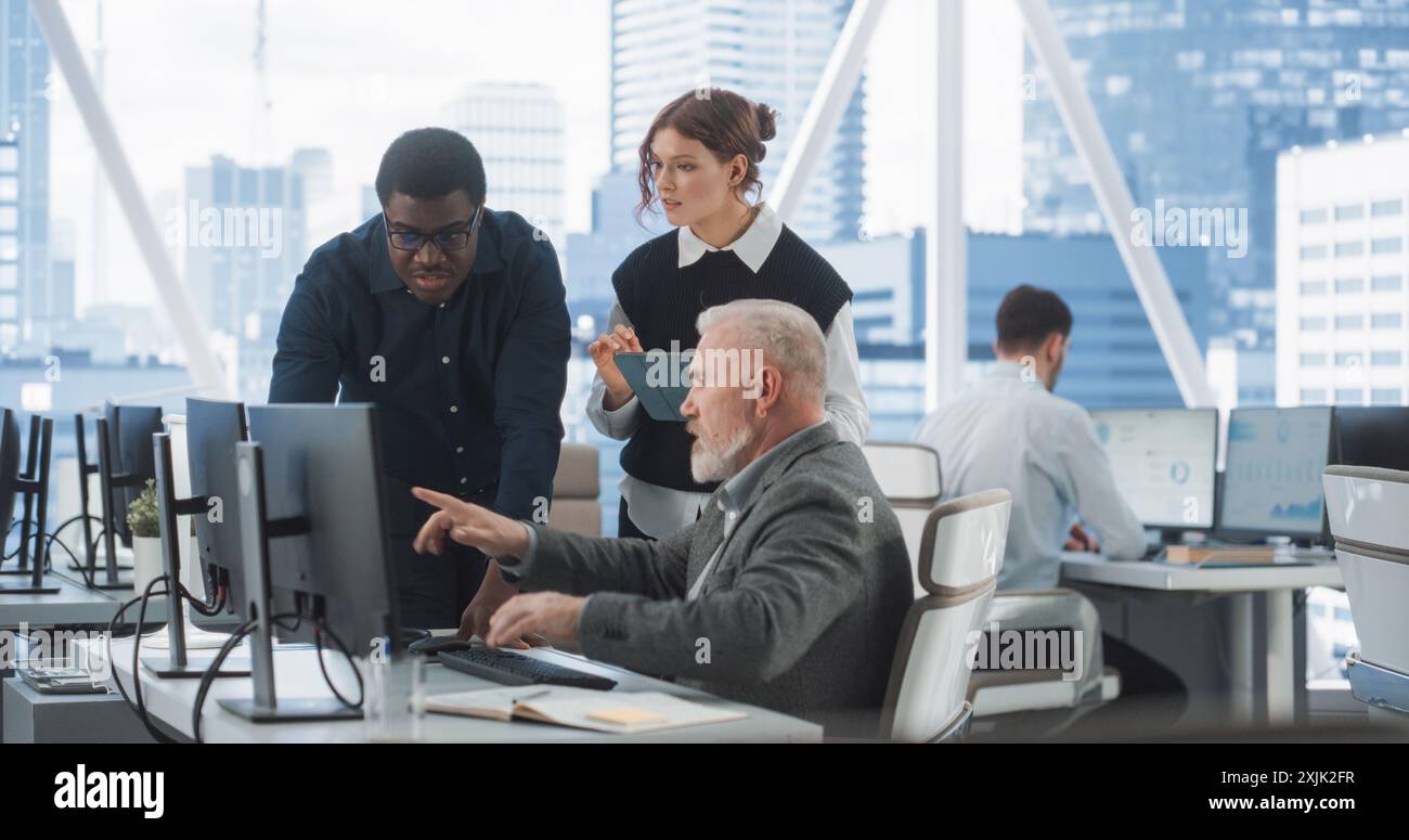 Diverse Colleagues Talking In Front Of Desktop Computer In Corporate ...