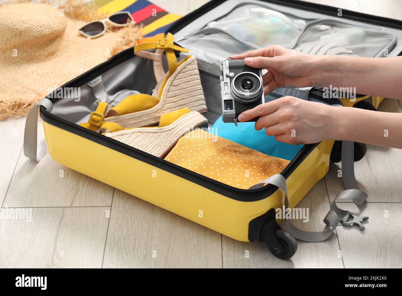 Woman packing suitcase for trip at home, closeup Stock Photo
