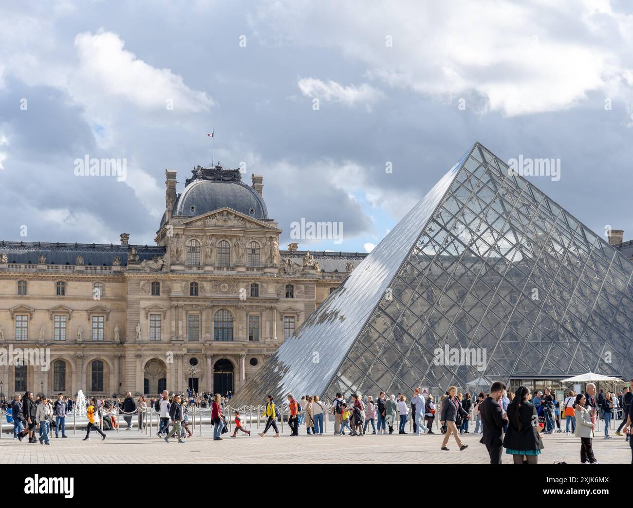Paris, France - October 19, 2023 : Tourists walk in front of the Louvre ...