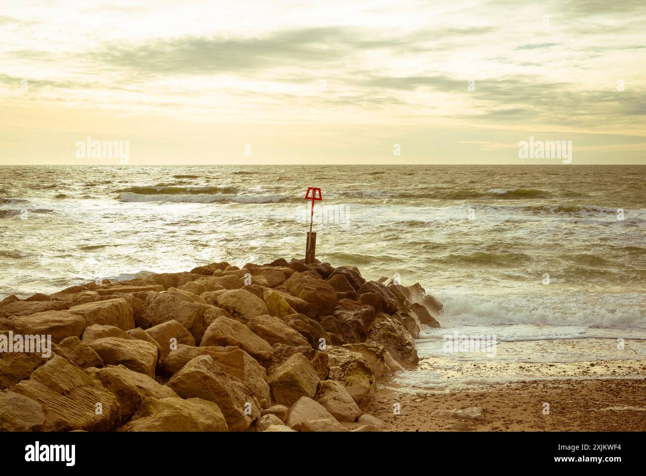 Seascape, coastal landscape with breakwater, rocks, waves, green hue, Hengistbury Head, Dorset Stock Photo