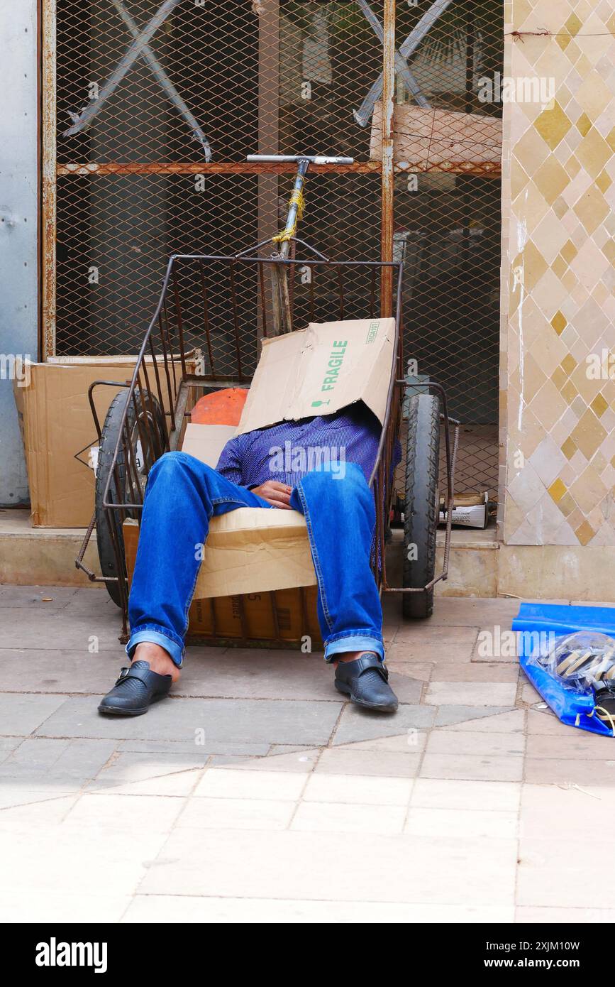 A porter from the Souk in Agadir takes a well earned rest. Stock Photo