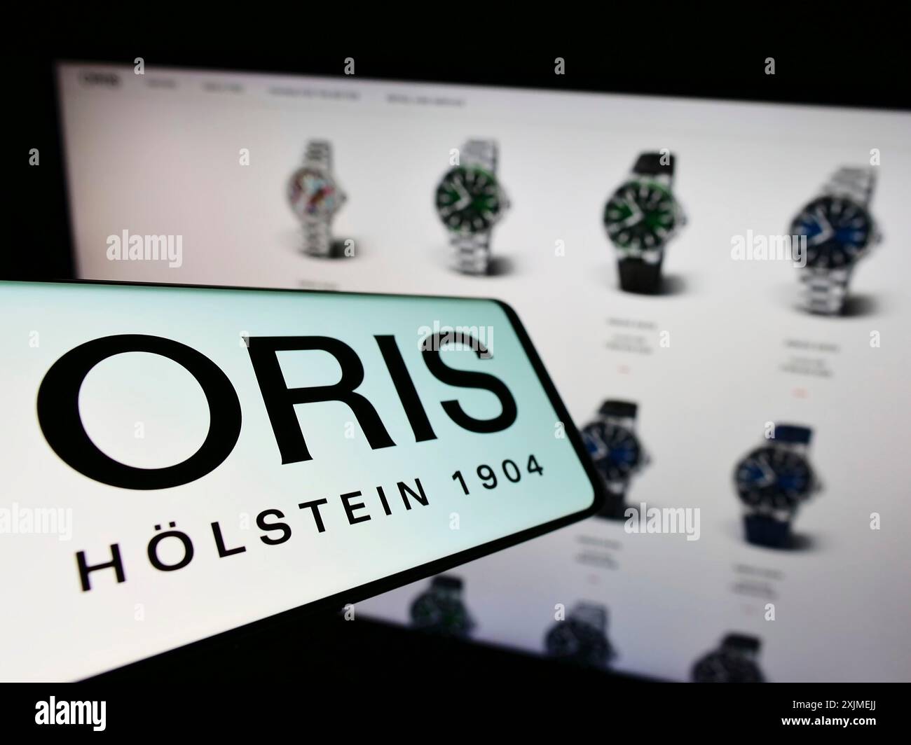 Stuttgart, Germany, 06-11-2022: Mobile phone with logo of Swiss watch manufacturing company Oris SA on screen in front of business website. Focus on Stock Photo