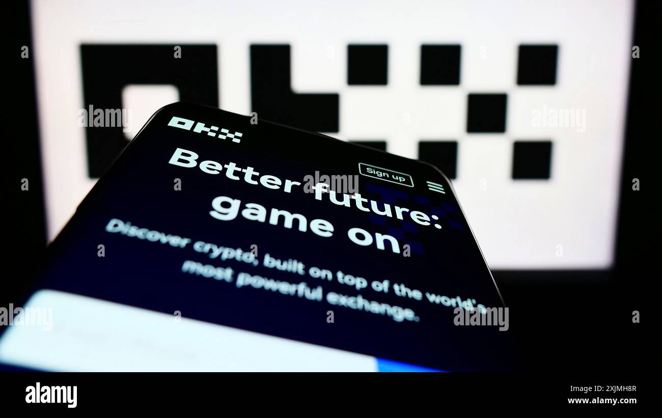 Stuttgart, Germany, 07-17-2022: Mobile phone with website of crypto company Aux Cayes FinTech Co. Ltd. (OKX) on screen in front of logo. Focus on Stock Photo