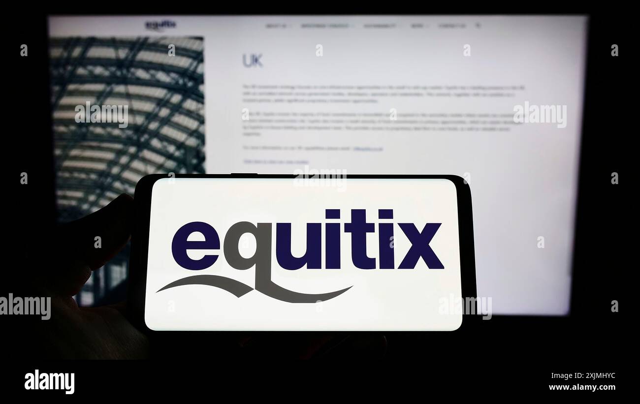 Stuttgart, Germany, 07-24-2022: Person holding smartphone with logo of company Equitix Investment Management Ltd. on screen in front of website. Stock Photo