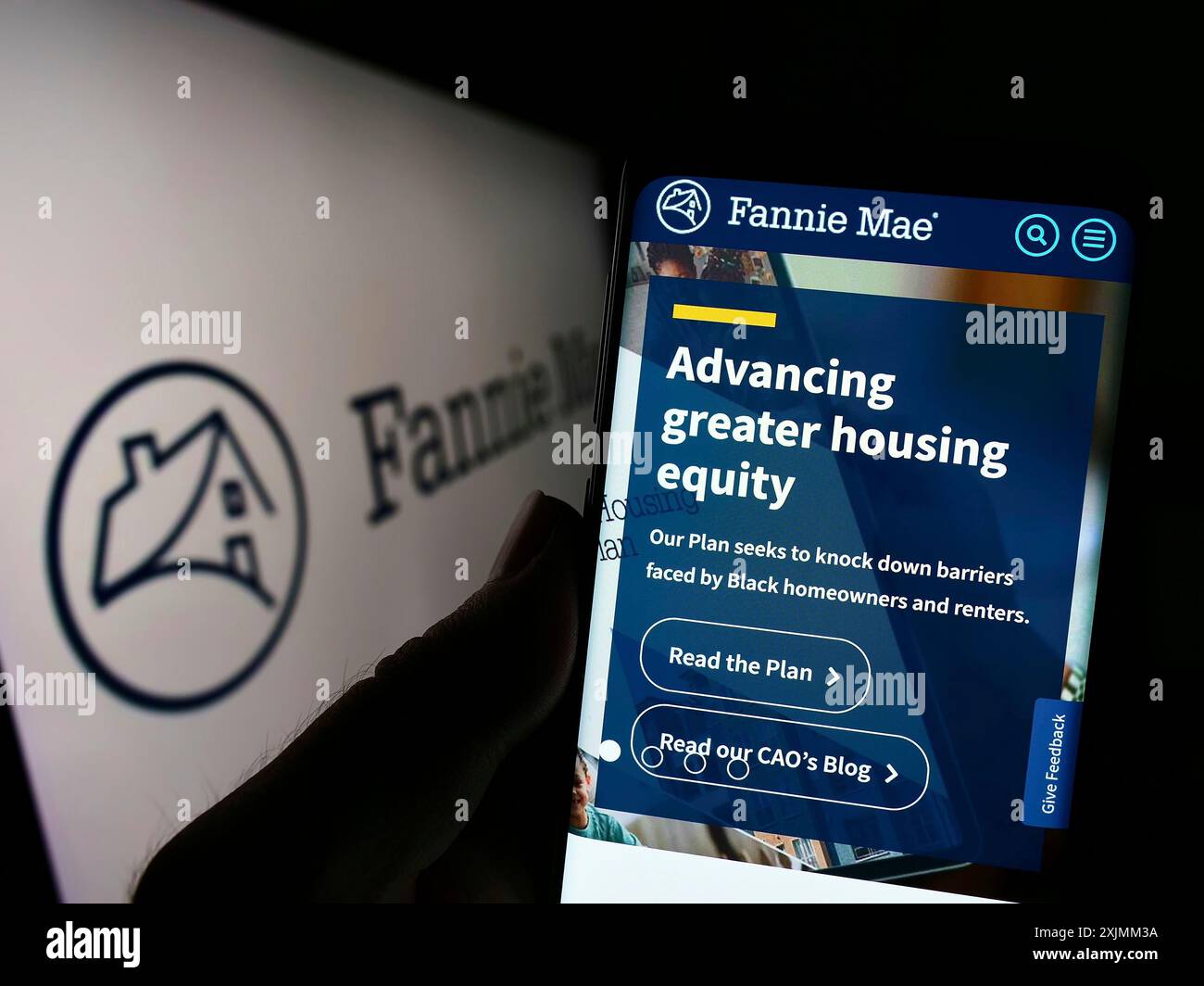 Stuttgart, Germany, 09-07-2022: Person holding cellphone with website of American financial company Fannie Mae (FNMA) on screen in front of logo. Stock Photo