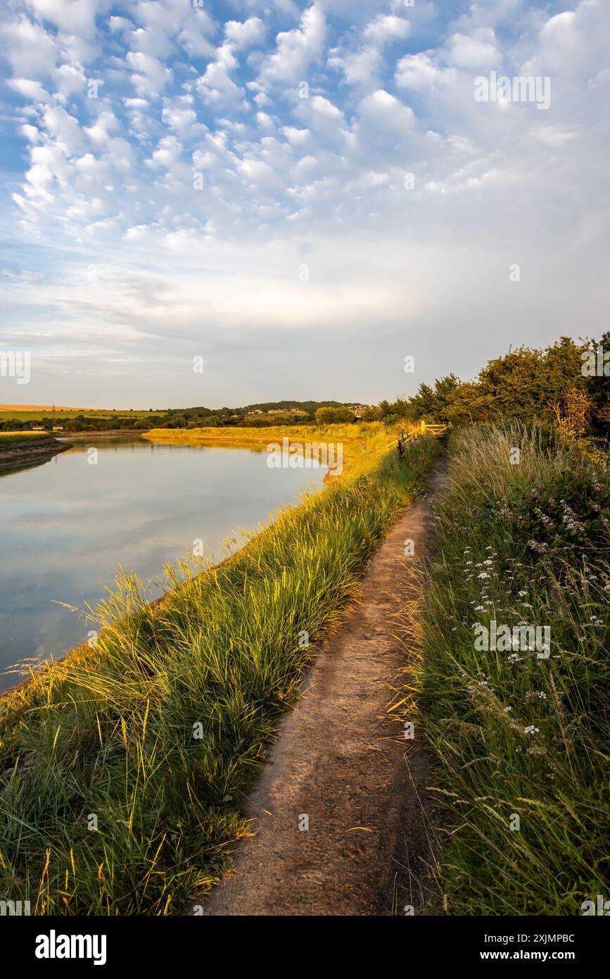 Looking along a pathway running next to the River Ouse, near Piddinghoe in Sussex Stock Photo