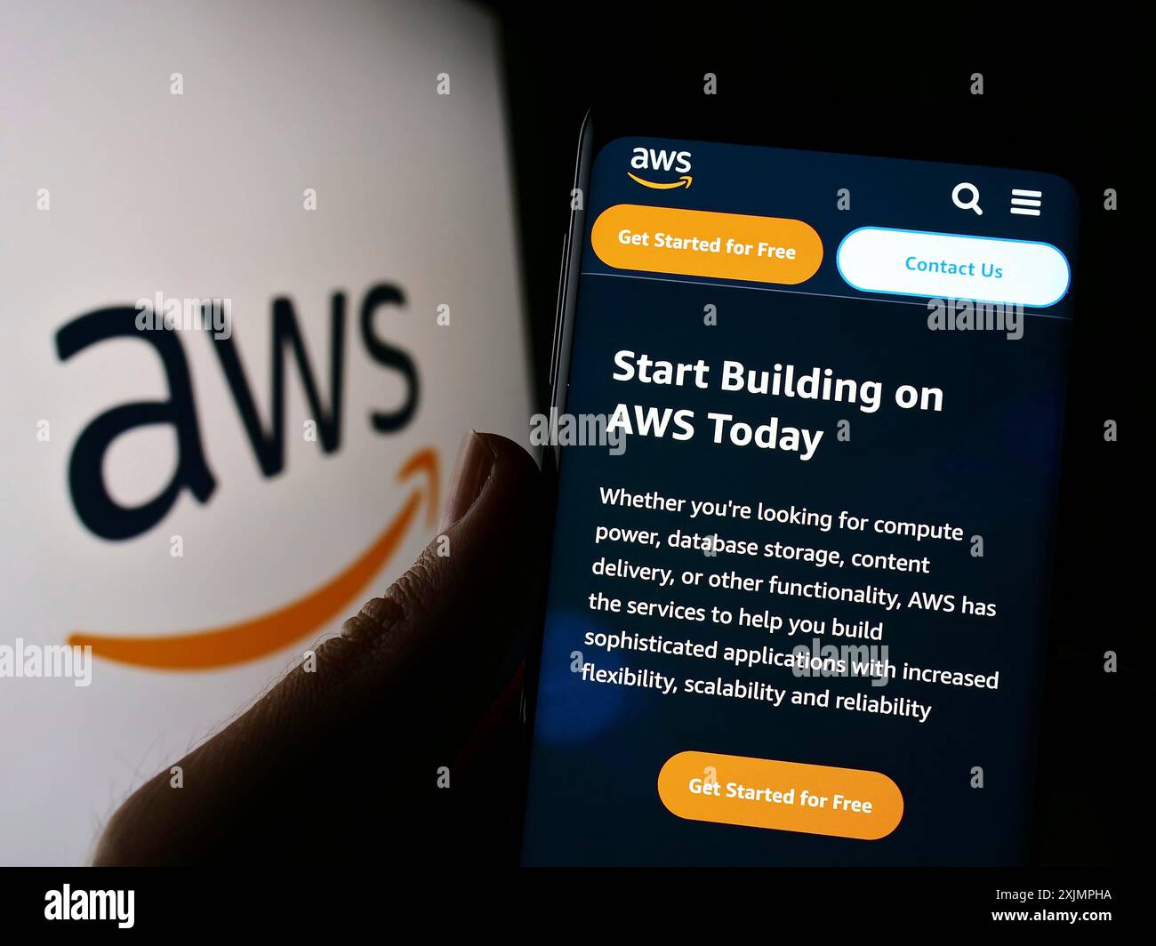 Stuttgart, Germany, 10-01-2022: Person holding cellphone with website of US cloud company Amazon Web Services Inc. (AWS) on screen with logo. Focus Stock Photo