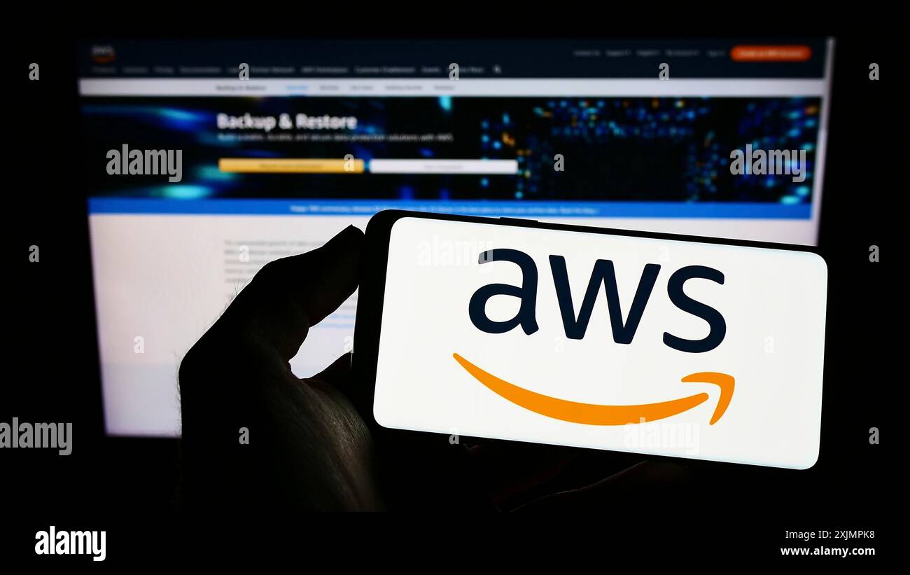 Stuttgart, Germany, 10-01-2022: Person holding cellphone with logo of American cloud company Amazon Web Services Inc. (AWS) on screen in front of Stock Photo