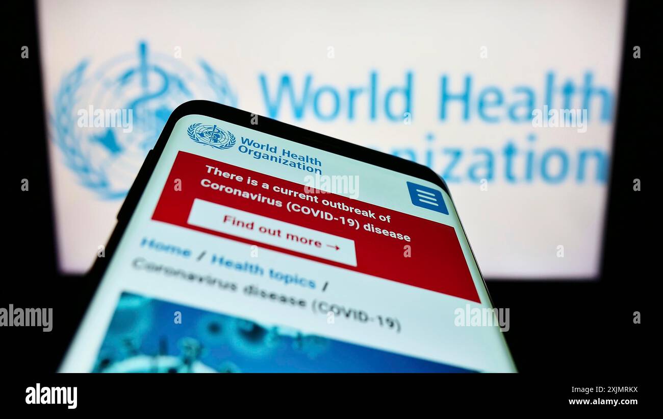 Stuttgart, Germany, 10-09-2022: Smartphone with webpage of United Nations agency World Health Organization (WHO) on screen in front of logo. Focus on Stock Photo