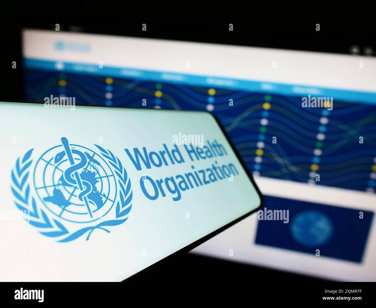 Stuttgart, Germany, 10-09-2022: Mobile phone with logo of UN agency World Health Organization (WHO) on screen in front of website. Focus on Stock Photo