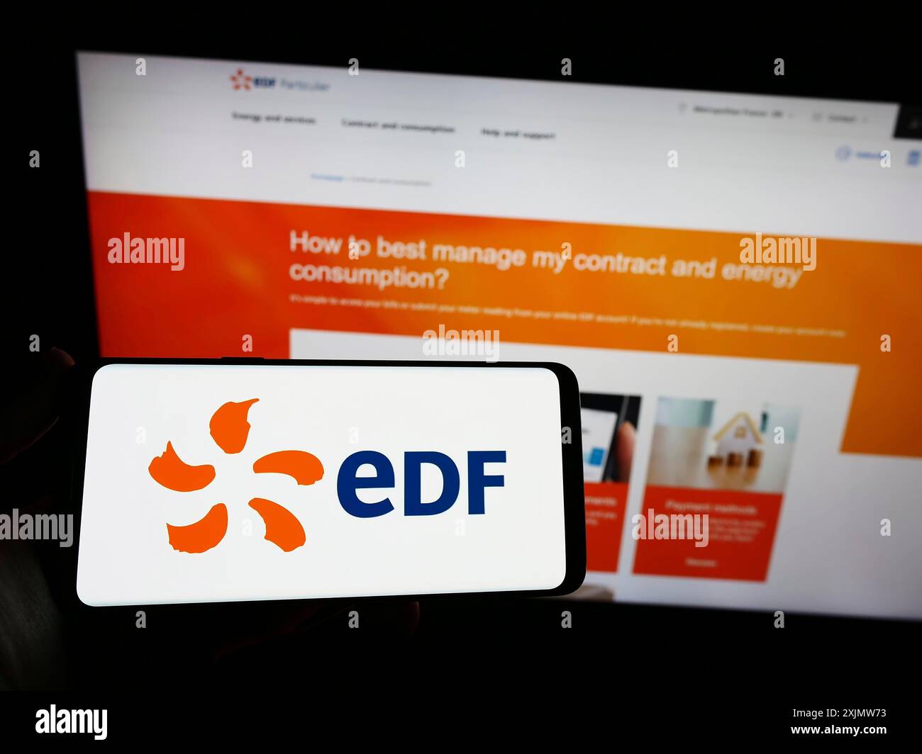 Stuttgart, Germany, 12-01-2022: Person holding smartphone with logo of energy company Electricite de France S.A. (EDF) on screen in front of website. Stock Photo