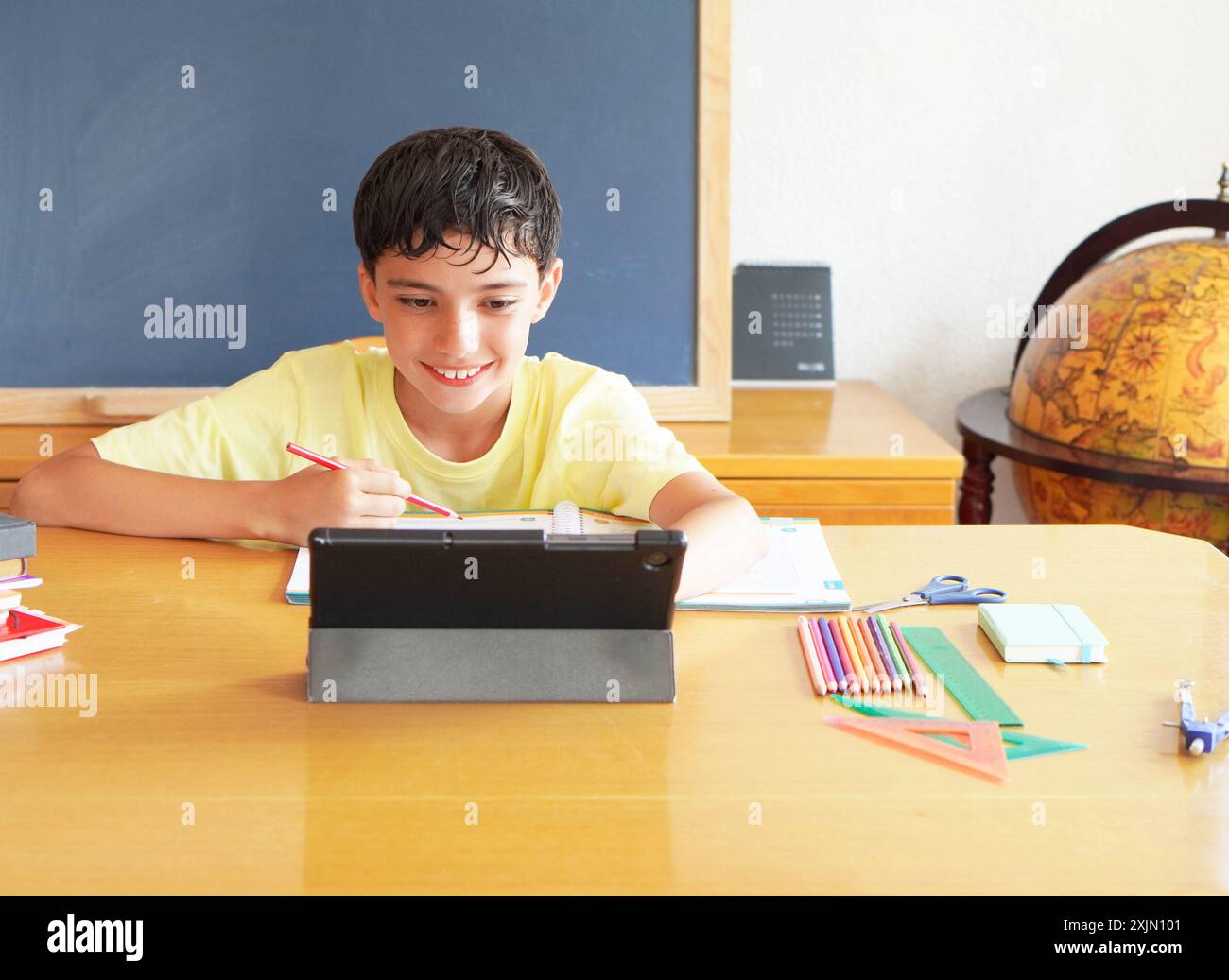 preadolescent child using tablet with digital educational material for an online class Stock Photo