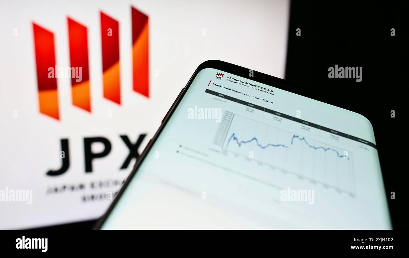 Stuttgart, Germany, 01-25-2023: Smartphone with webpage of company Japan Exchange Group Inc. (JPX) on screen in front of business logo. Focus on Stock Photo