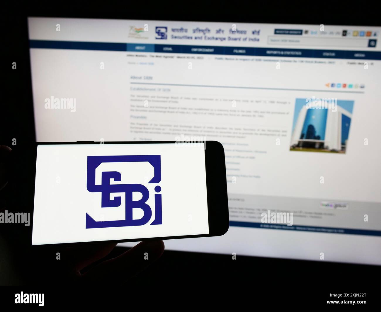 Stuttgart, Germany, 01-28-2023: Person holding smartphone with logo of Securities and Exchange Board of India (SEBI) on screen in front of website. Stock Photo