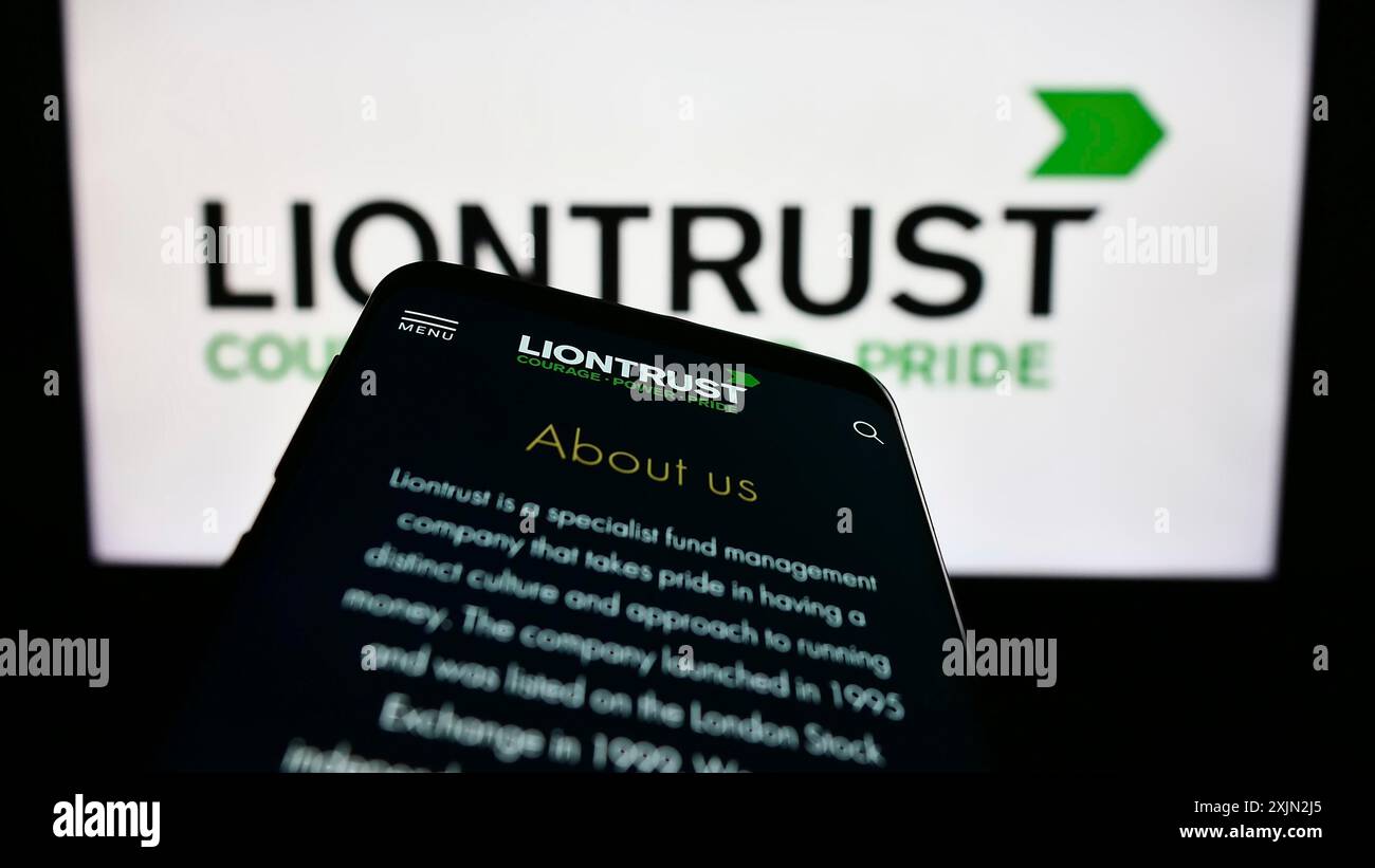 Stuttgart, Germany, 03-08-2023: Mobile phone with website of British company Liontrust Asset Management plc on screen in front of logo. Focus on Stock Photo