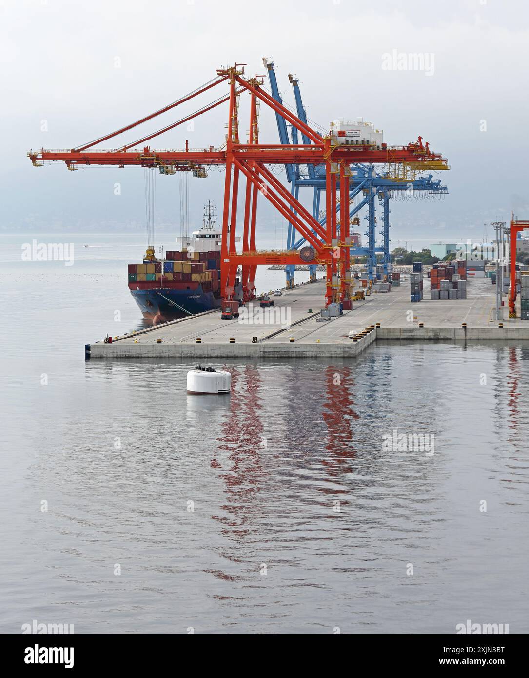Container ship docked at port with gantry cranes loading containers hi ...