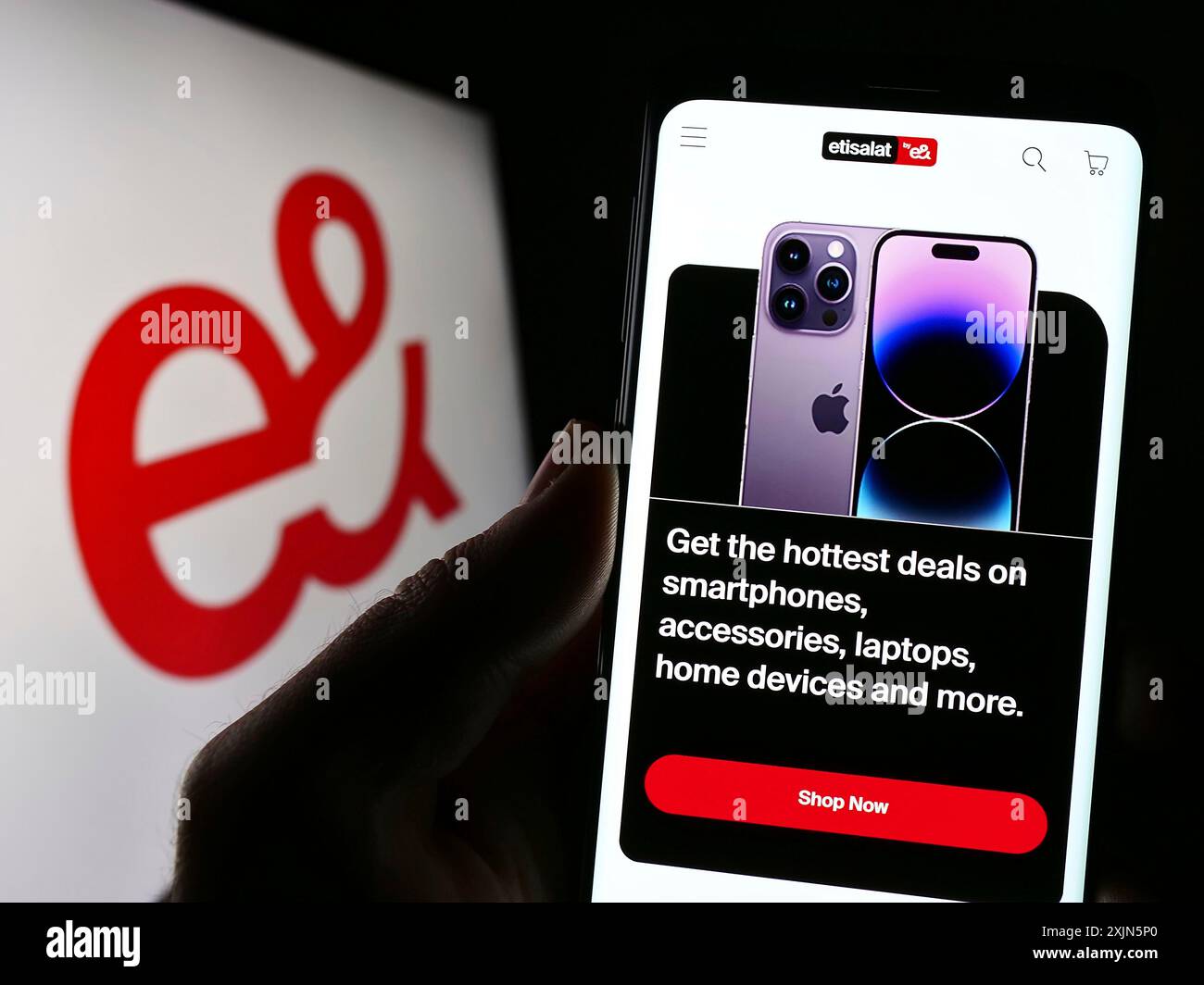 Stuttgart, Germany, 04-23-2023: Person holding smartphone with website of Emirates Telecommunications Group (etisalat) on screen with logo. Focus on Stock Photo