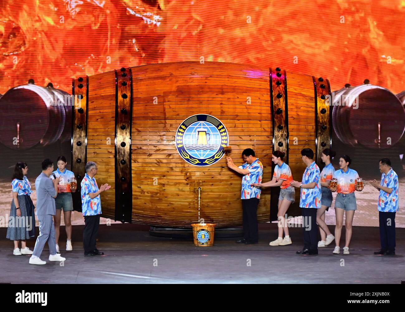 Qingdao. 19th July, 2024. Guests open the first barrel of beer at the opening ceremony of the 34th Qingdao International Beer Festival in Qingdao, east China's Shandong Province, July 19, 2024 The 34th Qingdao International Beer Festival kicked off in the coastal city of Qingdao on Friday, showcasing more than 2,200 varieties of beer from home and abroad. The 'summer carnival' will run for 24 days with a variety of activities held at the two venues in Laoshan District and the Xihai'an (West Coast) New Area of the city. Credit: Li Ziheng/Xinhua/Alamy Live News Stock Photo